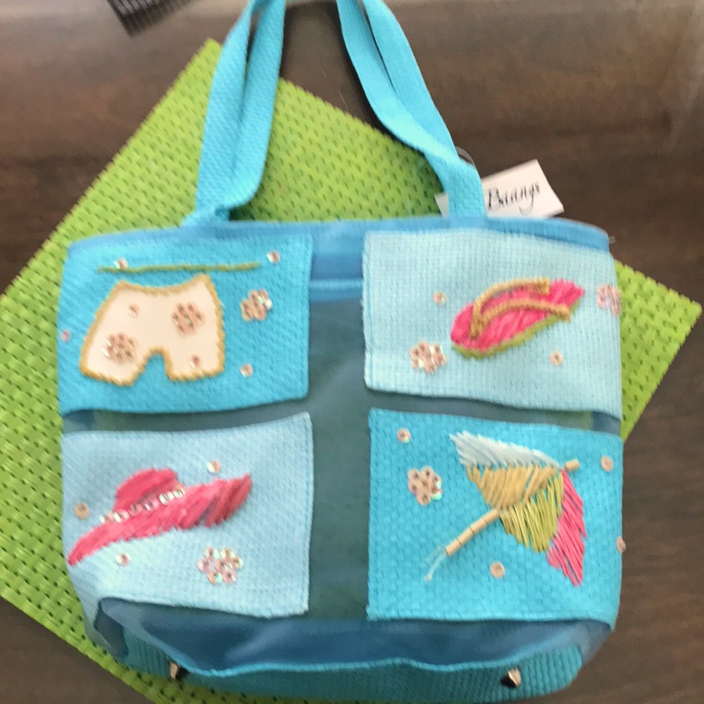 BAG NWT SHEER W UMBRELLA /HAT/SHORTS/FLIP FLOPS. Base of bag color is turquoise.